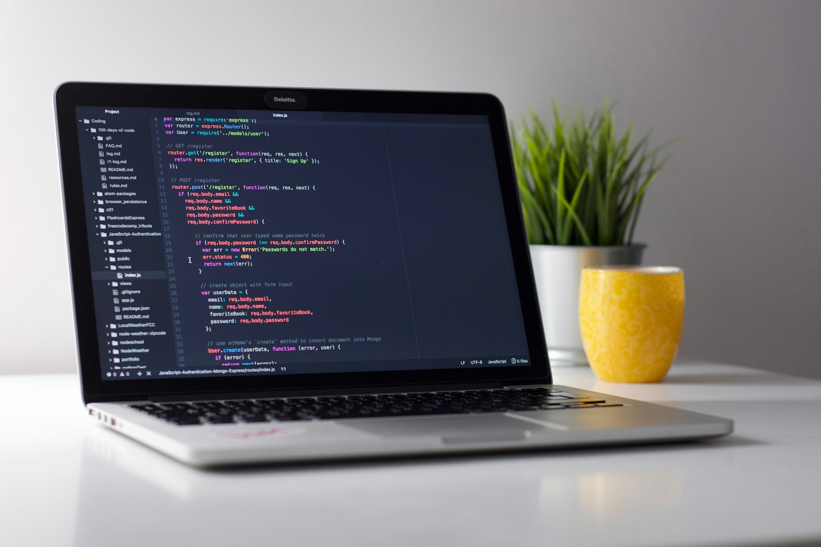 Laptop showing code in a bright workspace